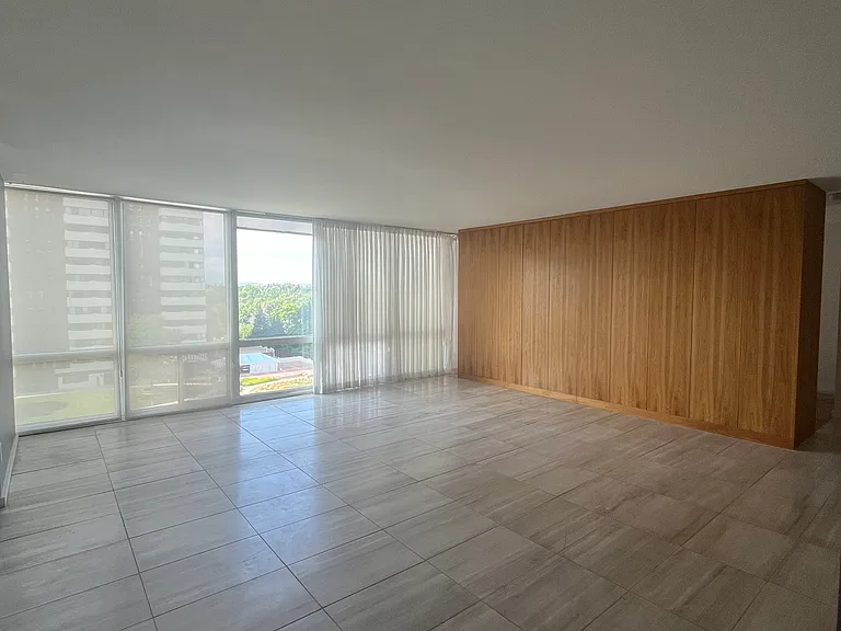 Large living room with travertine floors, beautiful wall of built-in closets, sleek appearance, floor to ceiling windows- fantastic light and Mountain Views