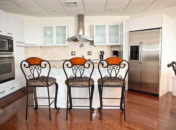 Modern Kitchen With Stainless Steel Appliances And Granite Counter Tops
