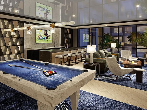 Expansive clubroom with wet bar, billiards, shuffleboard, and lounge areas.