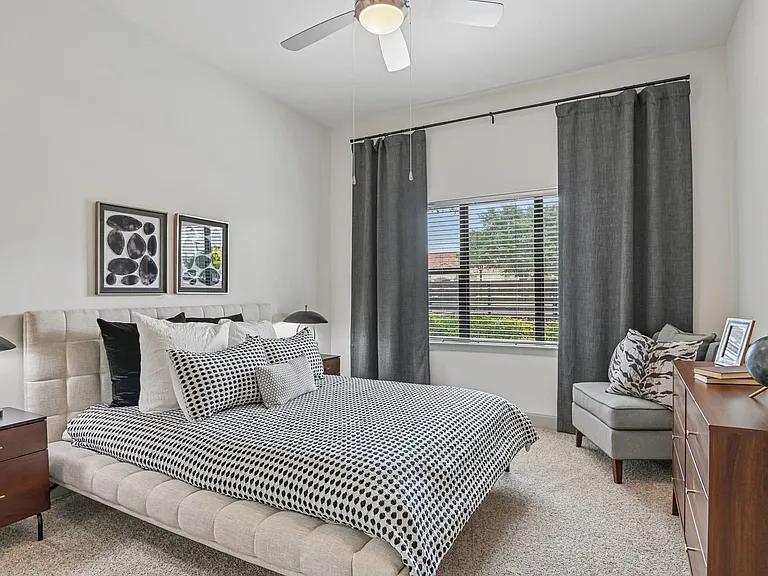 Markethaus 3700 A bedroom with a bed, nightstand, and a window with curtains.