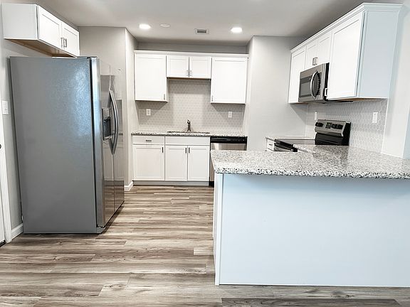 Updated kitchen with granite counters and stainless appliances