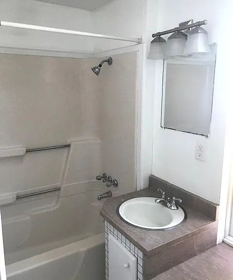 Custom granite vanity with bathtub/shower combo