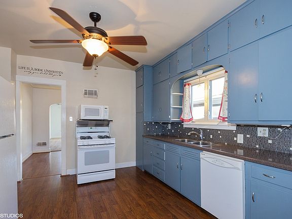 the kitchen with windows over the sink and a wall of cabinets!