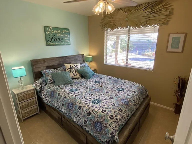 2nd bedroom with QUEEN has 6 drawers below bed for additional storage plus great view of the backyard!