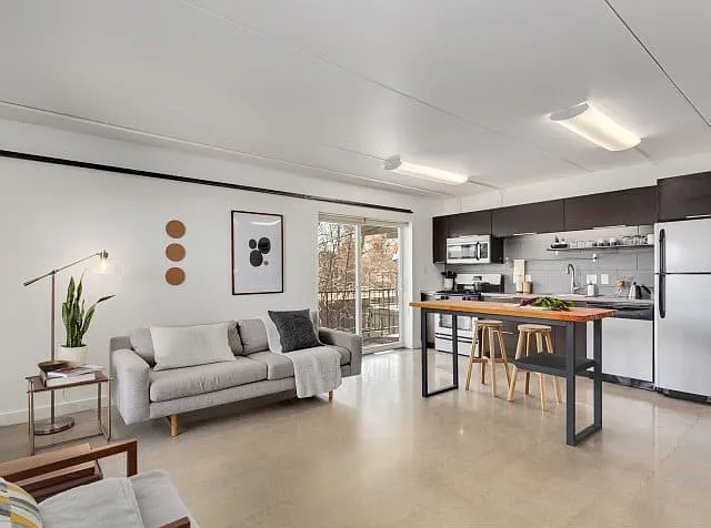 Living Room with polished concrete floors opens to stairs to private rooftop deck Living Room with polished concrete floors opens to stairs to private rooftop deck