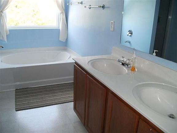 The master bath features a garden tub and a separate shower.