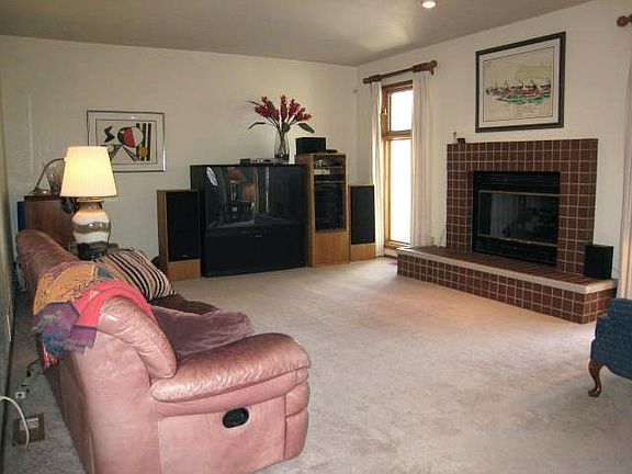 Light & bright family room w/ walk-out to custom covered porch & deck