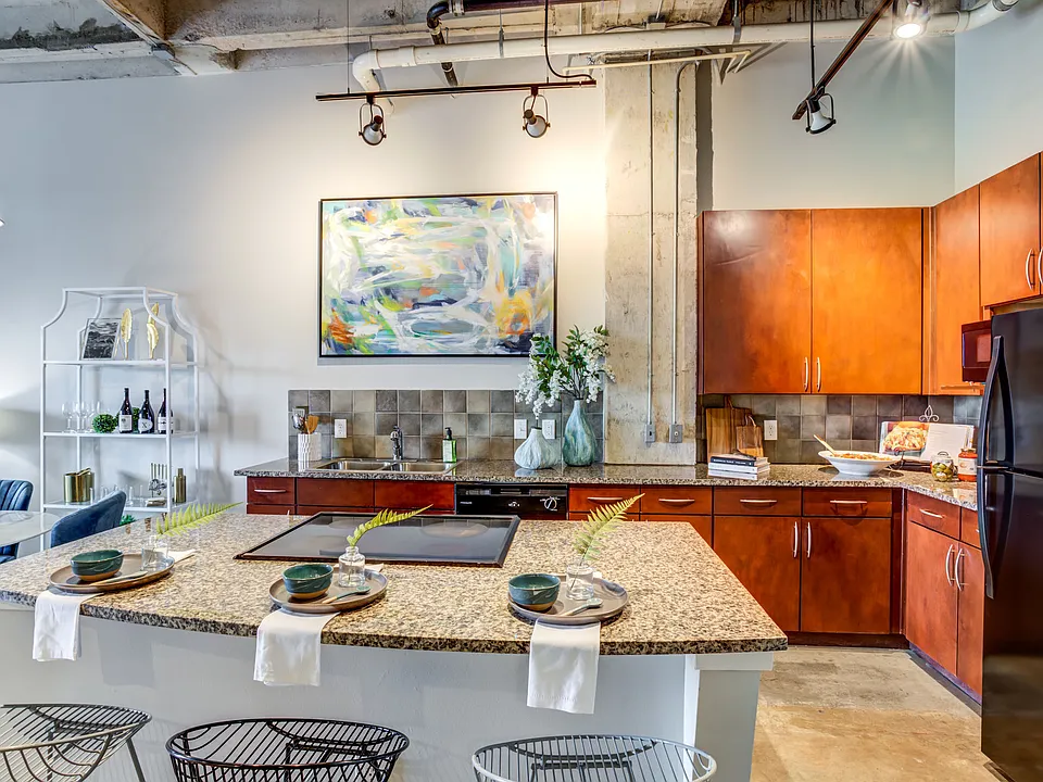Open-concept loft homes with modern kitchens at Hermann Park Lofts.