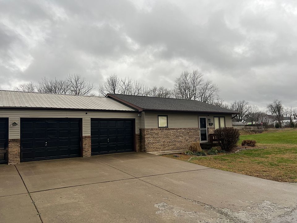 Front view showing 2 car garage and front door