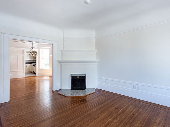 Living room leading into dining room, decorative fireplace