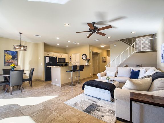 living room and open concept kitchen with dining area and breakfast bar with stools