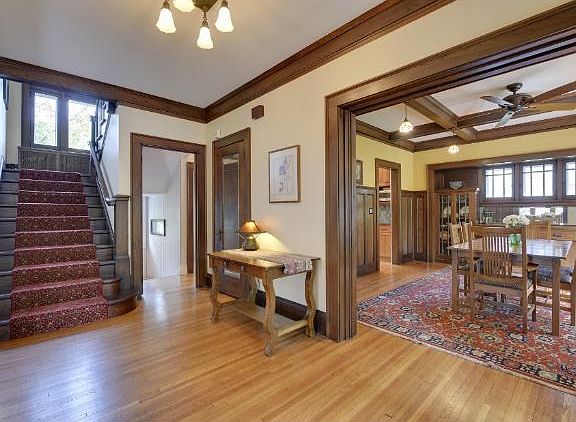 Grand entry filled with light and natural woodwork.