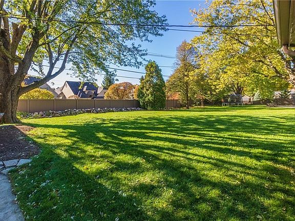 Large backyard with fence across the back