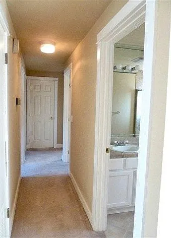 Hallway with two bathrooms and 3 bedrooms