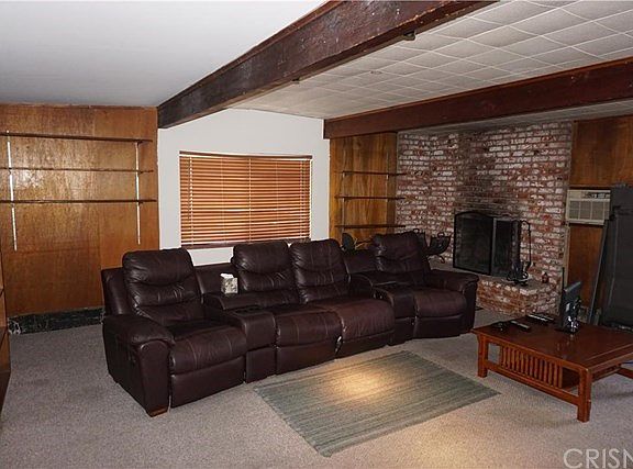 Large den with brick fireplace.