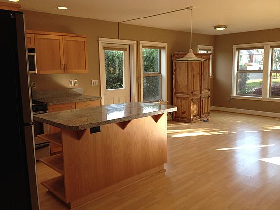 View of back door & kitchen island from stairs