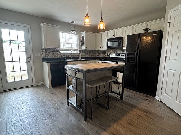 Updated kitchen with new Pergo flooring and updated lighting with large walk in pantry