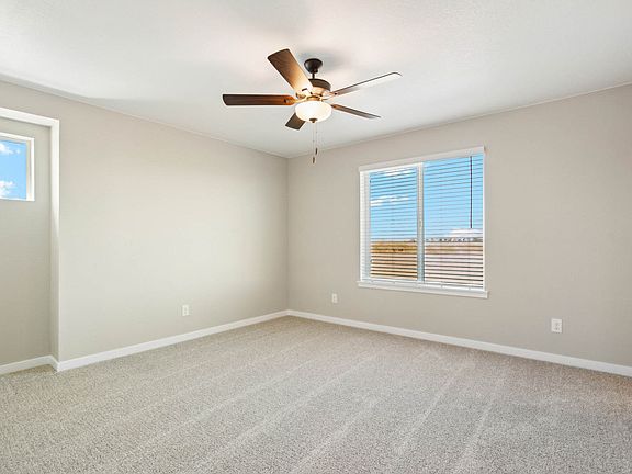 The master bedroom is spacious and has a large window.