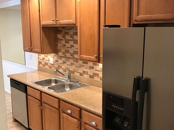 Kitchen with stainless steel refrigerator