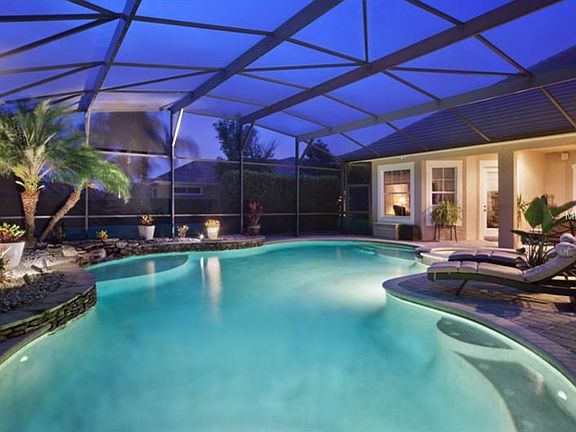 Salt water lagoon style pool and spa features rock waterfall and pebble finish