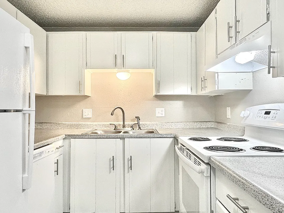 A bright, modern kitchen featuring white cabinetry, contemporary appliances, and an open layout designed for everyday living.