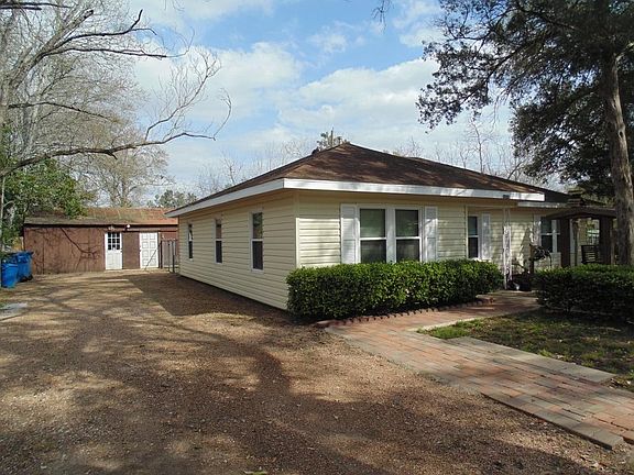 Side view of this fantastic home shows long drive way to hold all of your parking needs