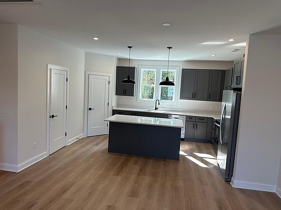 Kitchen showing powder room door and pantry in the corner