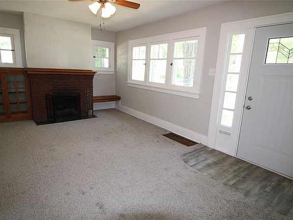 New ceiling, paint, carpet & fan in this cozy living room