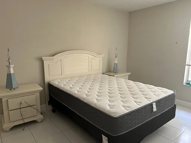 master bedroom has queen bed, 2 night stands, dresser and desk