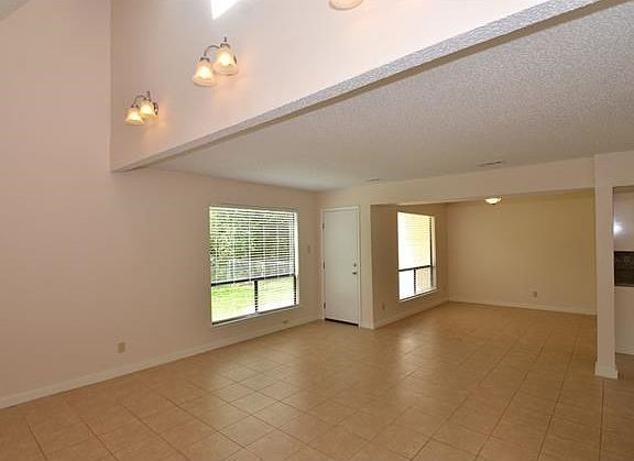 Open Tiled Family Room with View to Backyard; Tall Ceilings