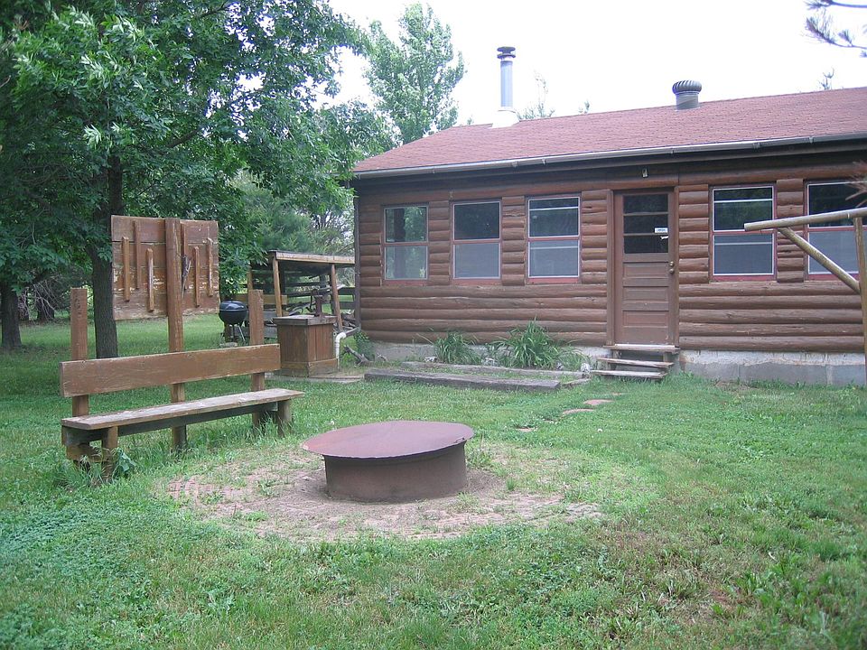 Looking to the Northwest.
--Fire pit with adjacent built-in bench. At back left a weber grill can be seen that is provided.
--On far right is a lantern rack