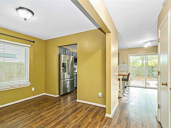 View from the 2 story entry to the Formal Dining Room on the left and the Eat in Kitchen and Family Room straight ahead.