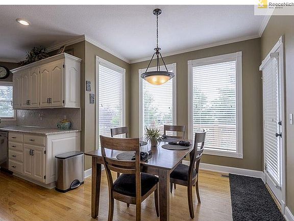 The Breakfast Dining Area has floor to ceiling windows, access to the deck, 2" wide blinds, hardwood floors and lovely overhead lighting.