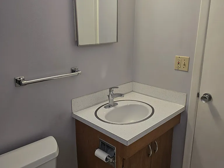 View of bathroom vanity and door