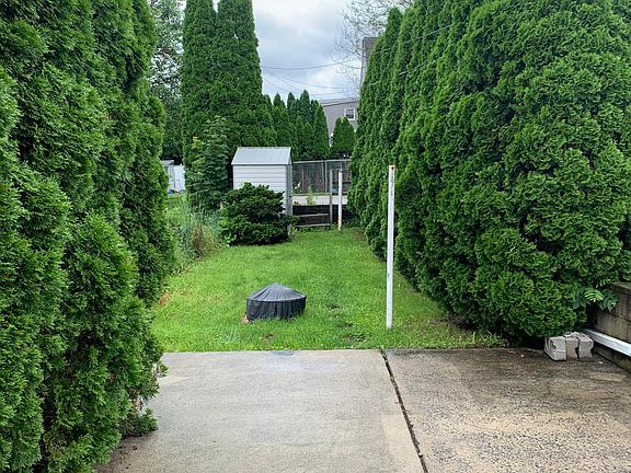 Back Yard (w/ Fire Pit, Shed (w/ Lawn Mower), Parking Space in Back
