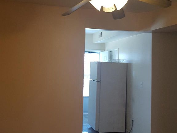 Dining room with ceiling fan.