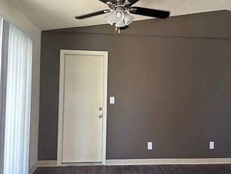 Dining area with new paint, new vertical blinds, door to attached oversized 1-car garage, and ceiling fan