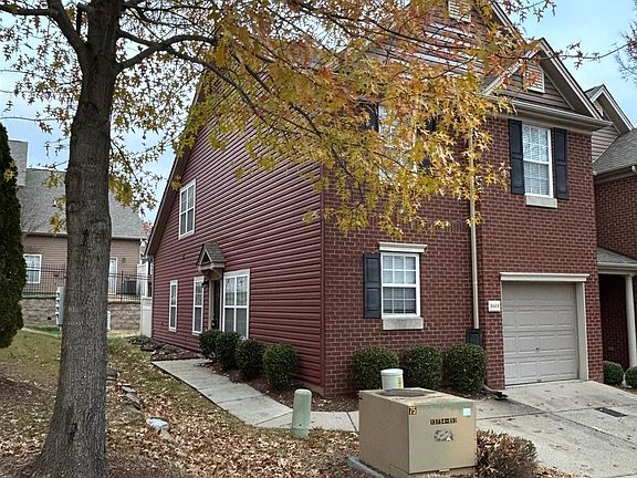 Corner town house with lots of windows.