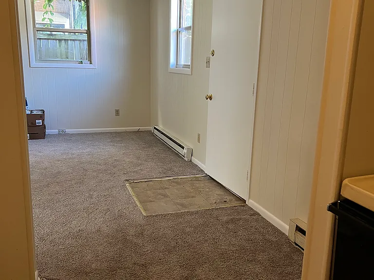 View of front door from kitchen