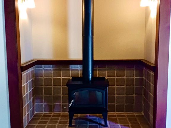 Efficient wood-burning stove is an alternate heat source for heating the house.