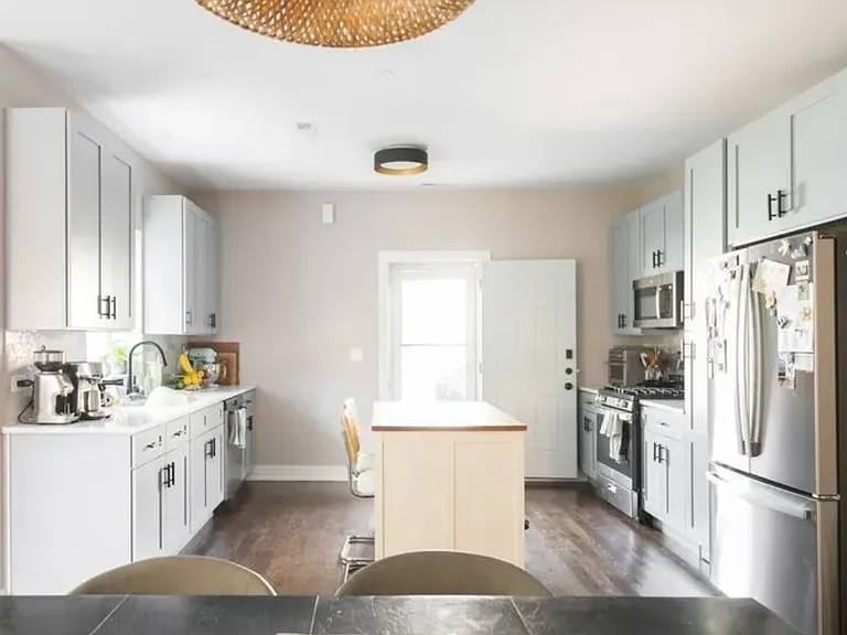 Newly remodeled kitchen with gas range, dishwasher, refrigerator with ice-maker and water dispenser, and movable island