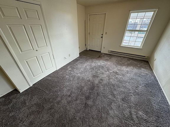Living room and entryway with closet.