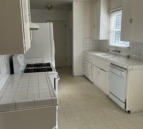 Crisp, bright, clean galley style kitchen