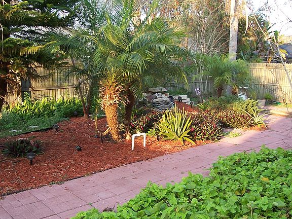 backyard with pavers and small pond