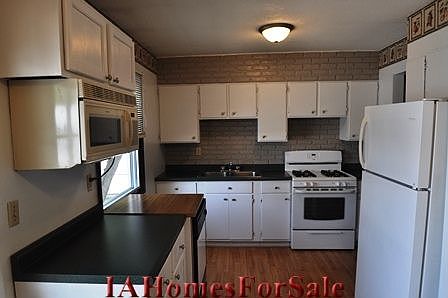 Kitchen with new gas stove.  All appliances stay.