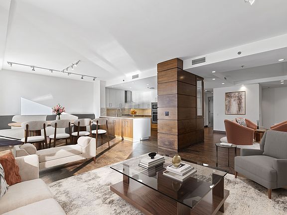 Unique and open floorplan. The double parlor living room has 2 living areas and a large dining area off the kitchen. Custom walnut woodwork thruout the living area. (Virtually staged image)