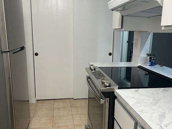 Kitchen with Glass top Stove and pantry