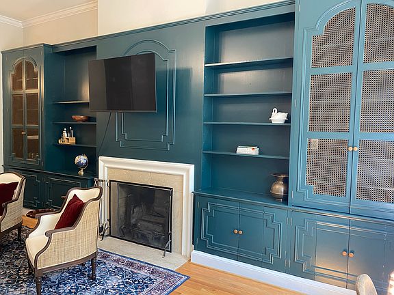 Wall of built-ins and working fireplace