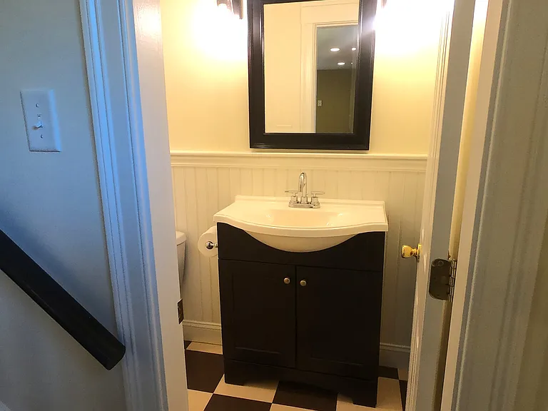 Bathroom, located at foot of stairs.