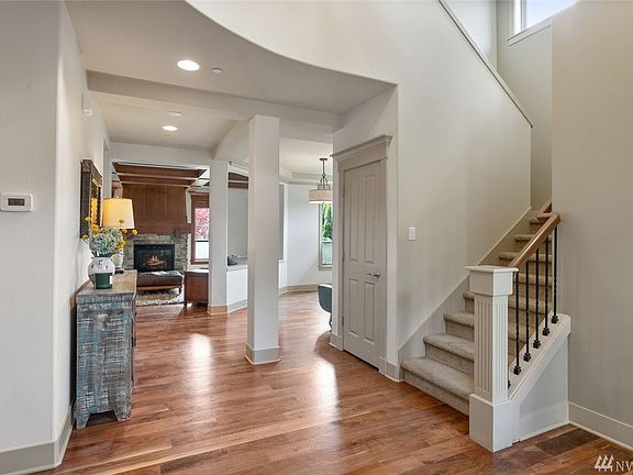 Stunning 2-story entry with newer wide plank walnut hardwood floors throughout main level. 
